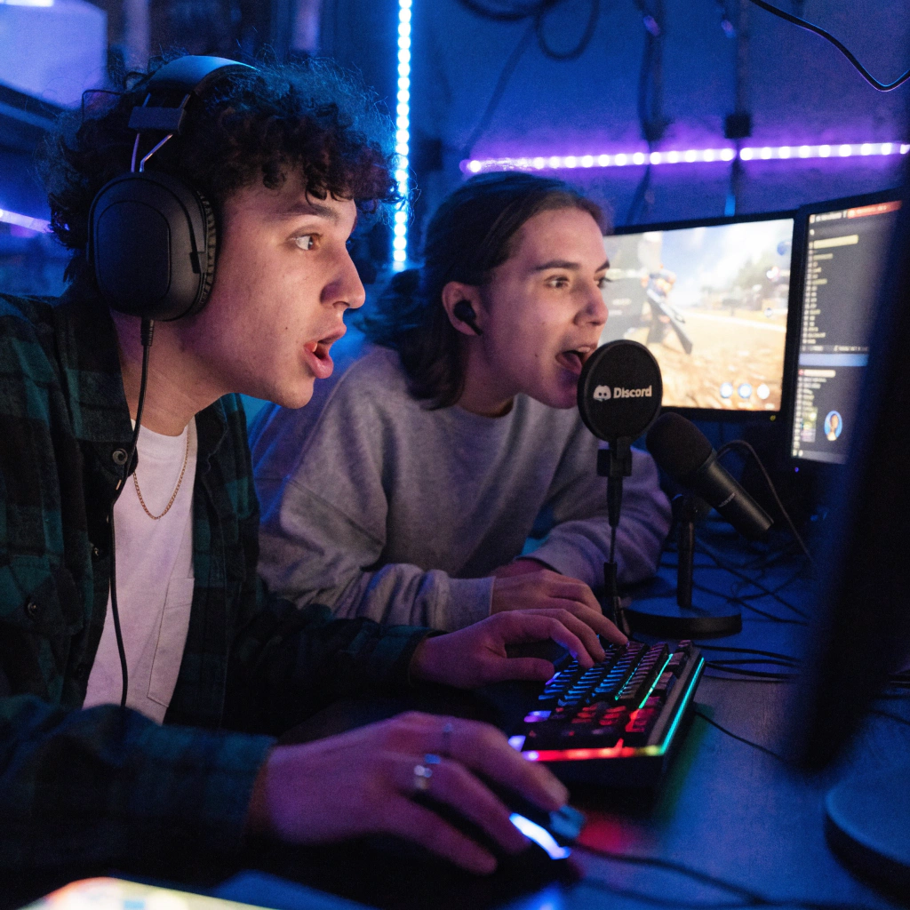 Two gamer friends playing together with headsets